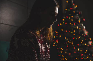 lonely woman showing christmas tree on her back